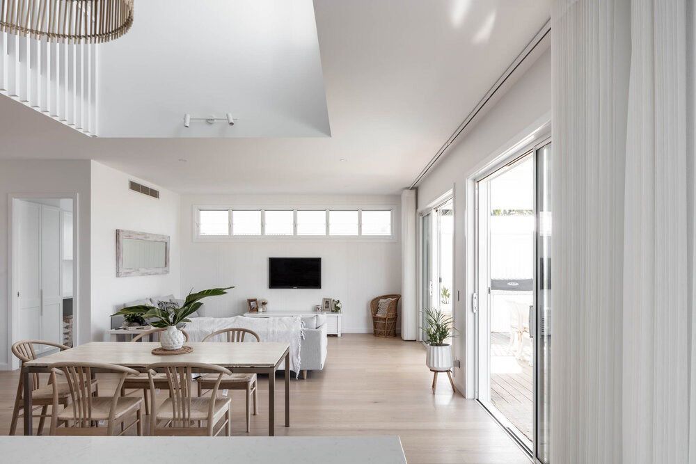 A Living Room With a Table and Chairs and a Television — DeBu Studios In Russell Vale, NSW