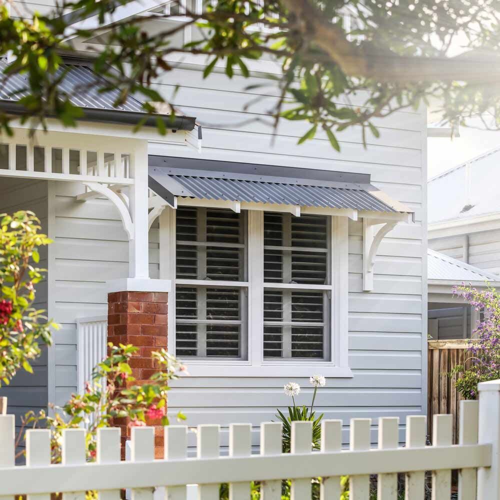 A White House With a White Picket Fence and a Large Window — DeBu Studios In Russell Vale, NSW