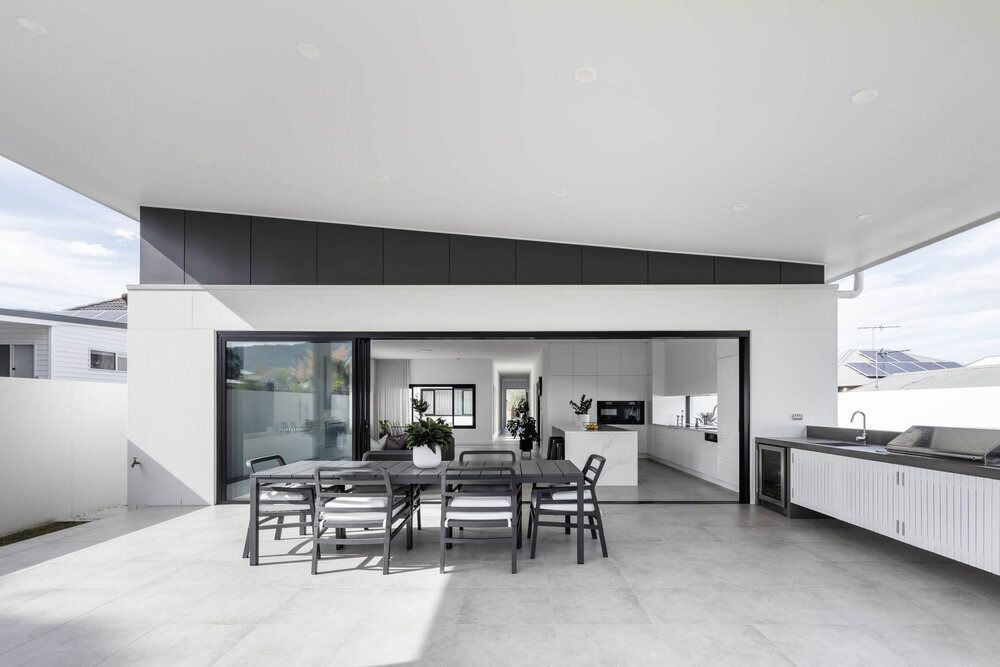 A Black and White Photo of a Patio With a Table and Chairs — DeBu Studios In Russell Vale, NSW