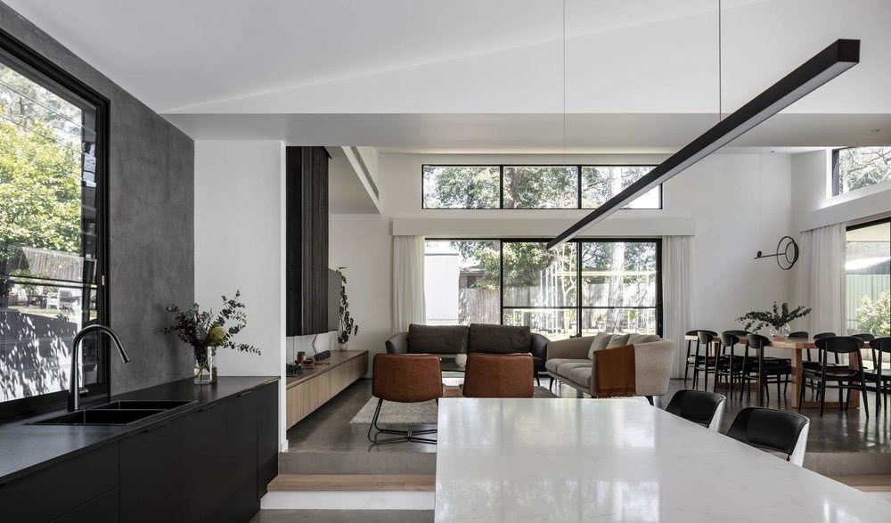 A Living Room With a Dining Table and Chairs and a Kitchen — DeBu Studios In Russell Vale, NSW