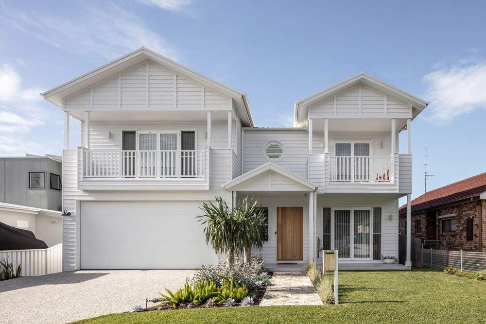 A Large White House With a Lot of Windows and a Garage — DeBu Studios In Russell Vale, NSW