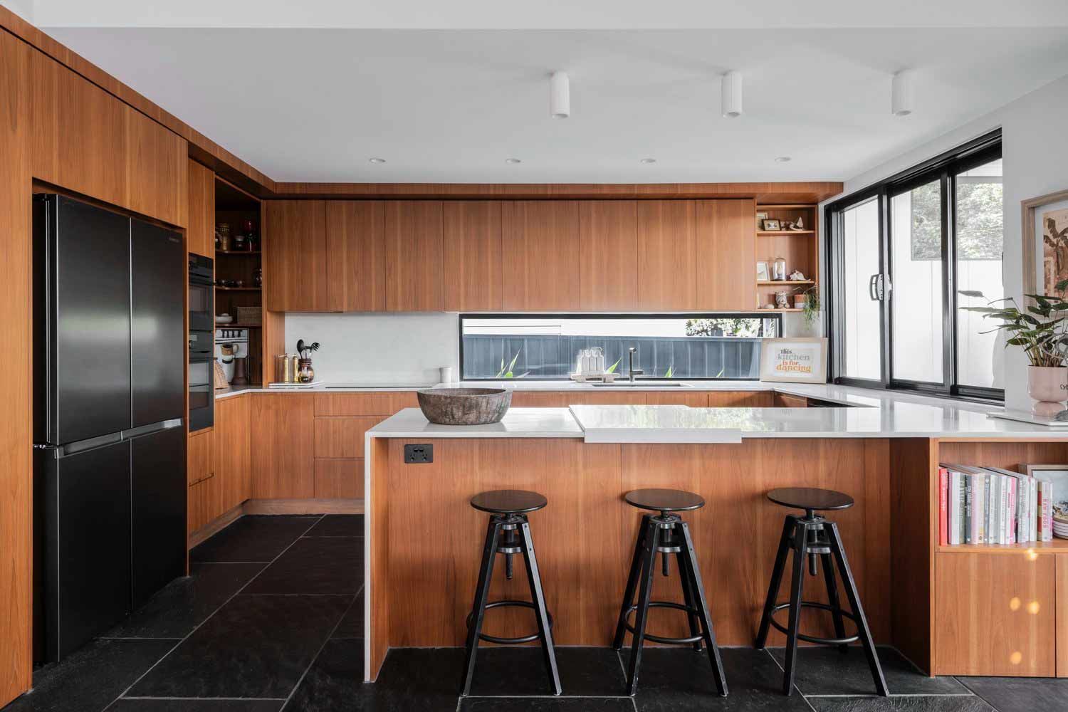 A Kitchen With Wooden Cabinets — DeBu Studios In Russell Vale, NSW