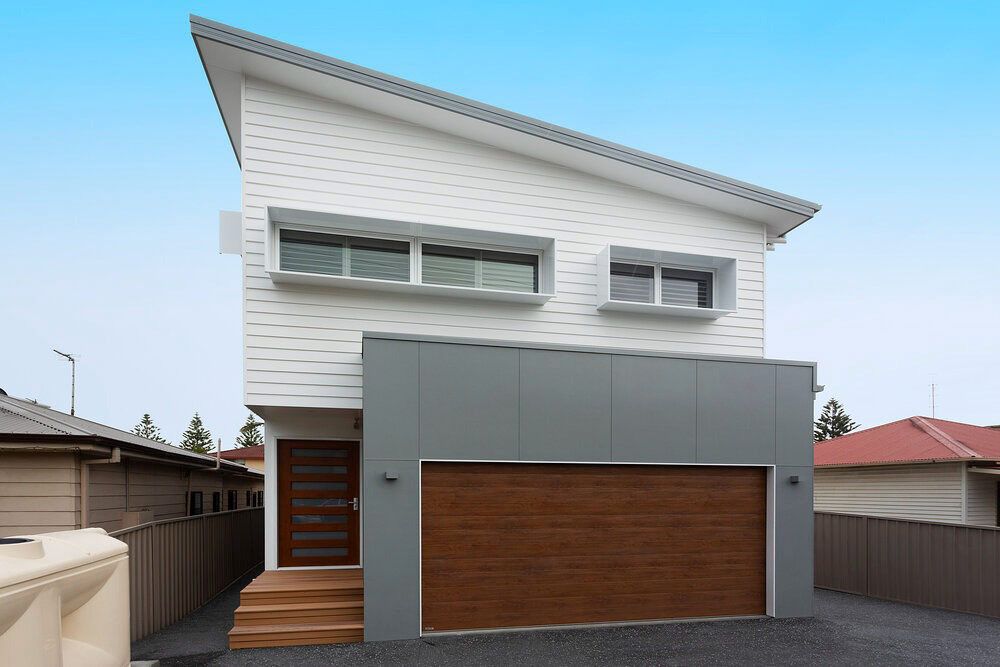A White House With a Brown Garage Door — DeBu Studios In Russell Vale, NSW