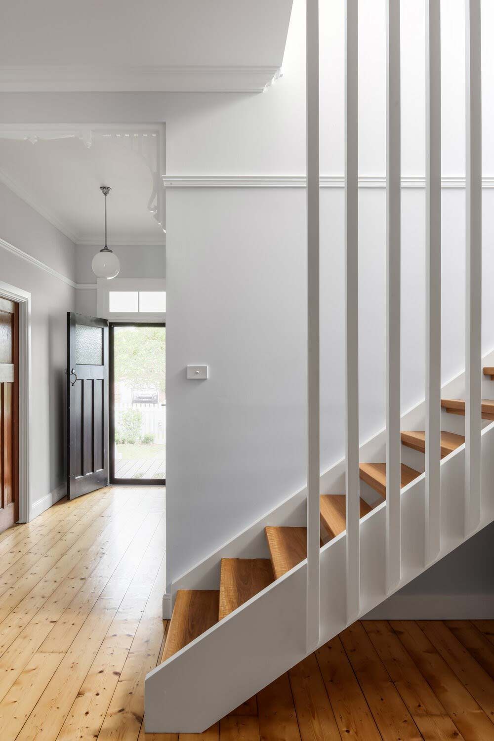 A Staircase With Wooden Steps and a White Railing in a Hallway — DeBu Studios In Russell Vale, NSW