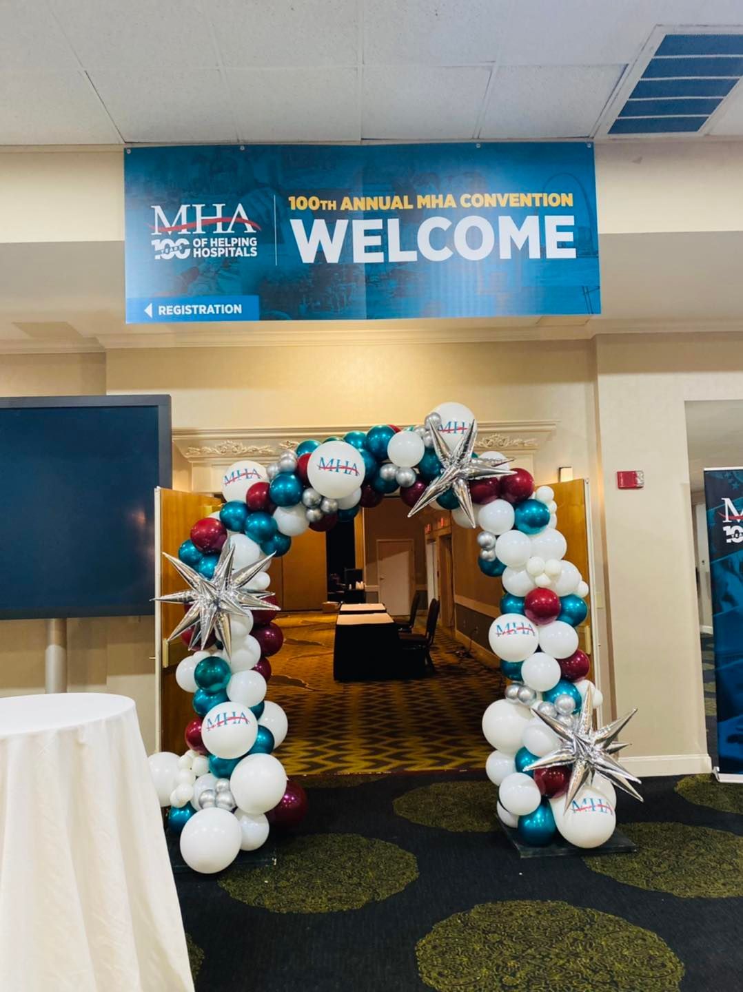 Balloon arch welcoming entrance to an MHA annual convention, with a “WELCOME” banner above.