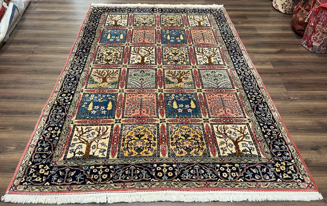 Colorful patchwork rug with floral and geometric squares on a wood floor