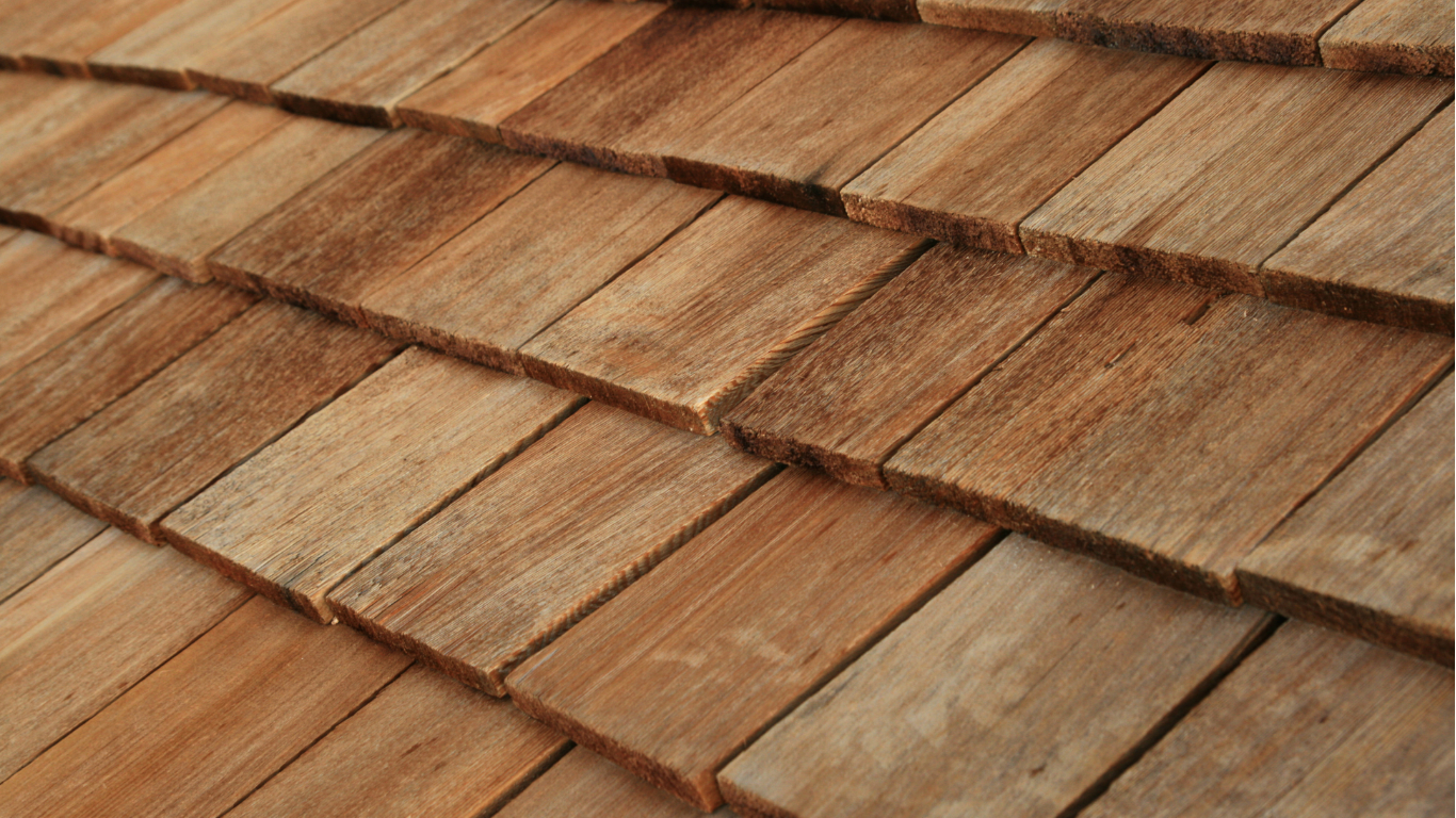 Close-up of a weathered, textured cedar shake roof.