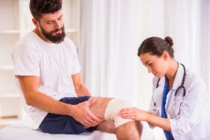 Nurse Checking Patient Knee — Clarksville, AR — Phil Taylor Insurance Agency, Inc. Nurse Checking Patient Knee — Clarksville, AR — Phil Taylor Insurance Agency, Inc.
