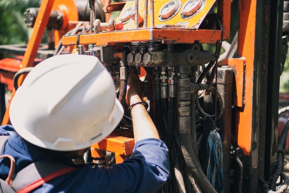A Man Wearing a Hard Hat is Working on a Machine — 4off Automotive & Electrical In Bowral, NSW