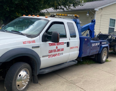White tow truck with the phone number 313-478-5333 and the phrase “Cash for junk cars on the spot” against a black background. White tow truck with the phone number 313-478-5333 and the phrase “Cash for junk cars on the spot” against a black background.