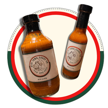 Two amber sauce bottles with black caps on a red and green circular background.