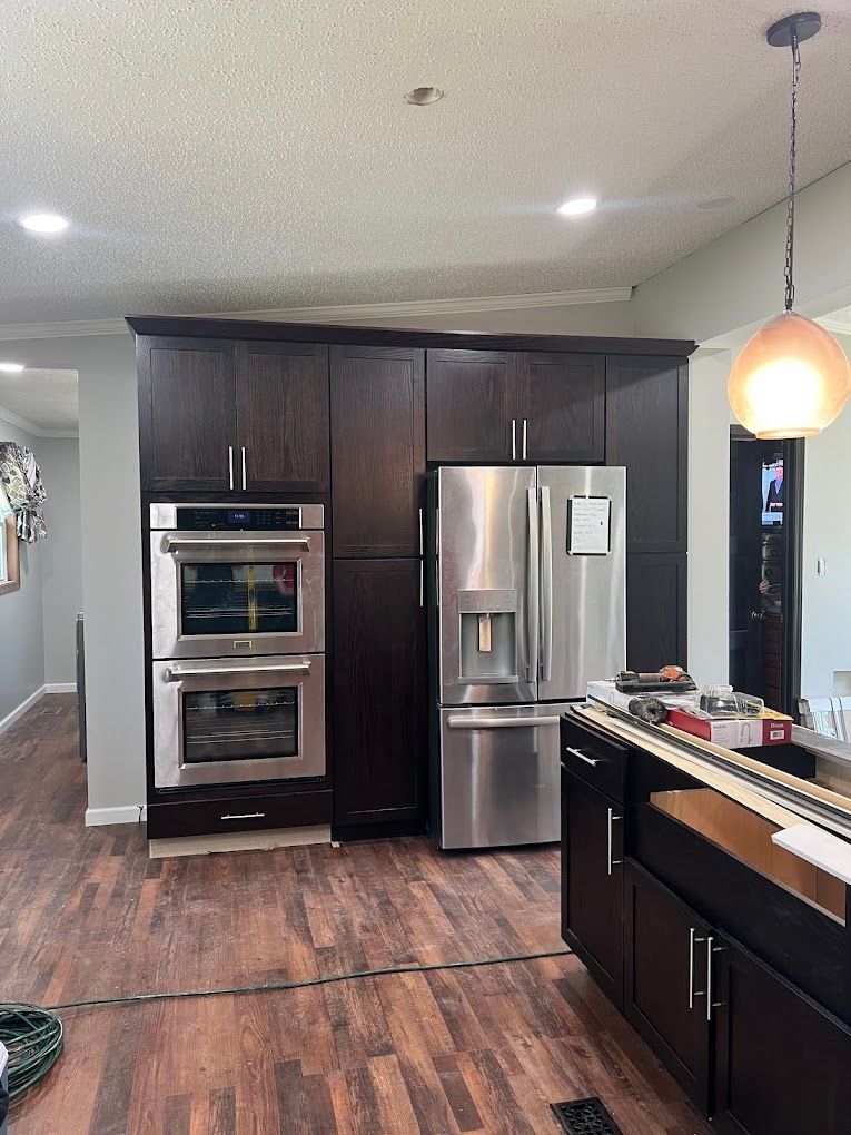 A kitchen with stainless steel appliances and wooden cabinets.