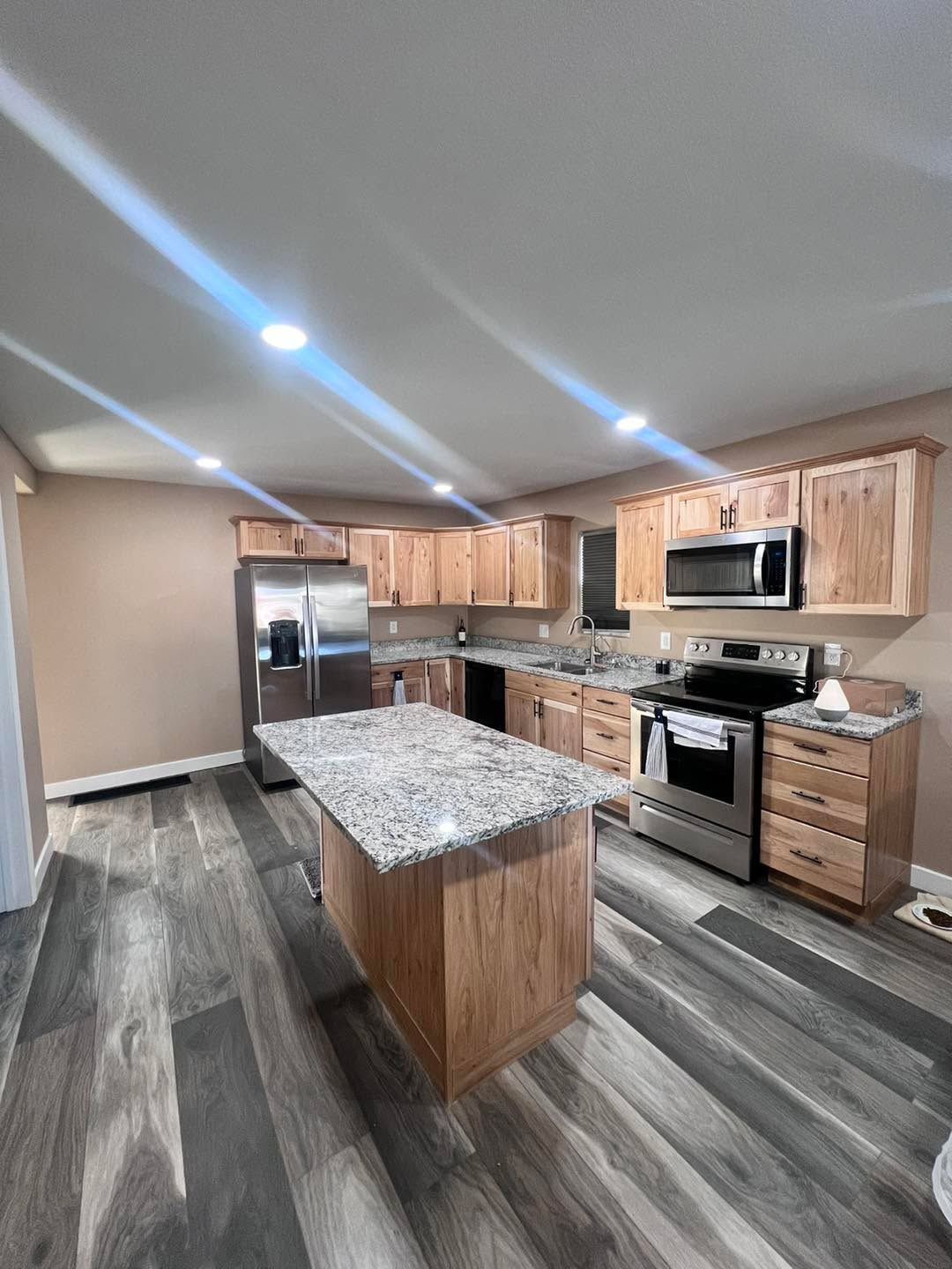 A kitchen with stainless steel appliances and wooden cabinets