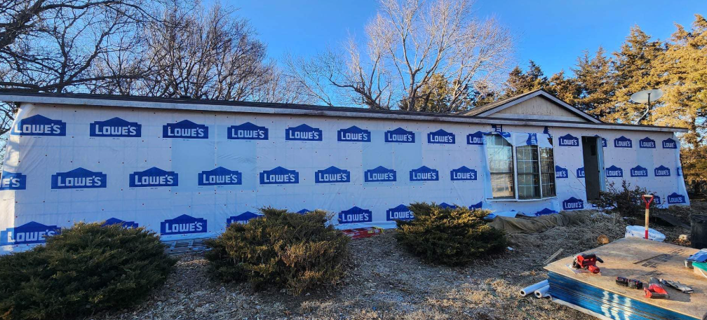 A house is being built with a lot of blue insulation.