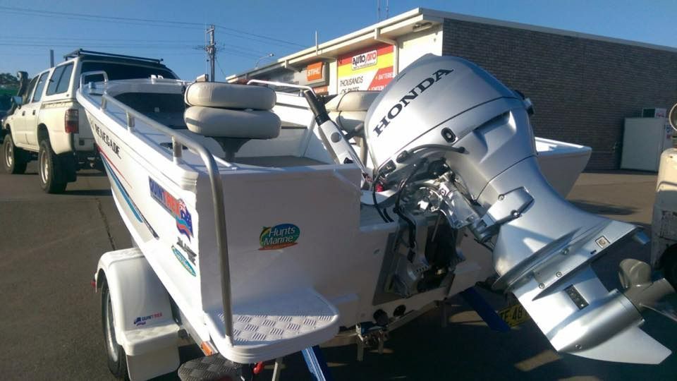 A Boat With A Honda Outboard Motor Attached To It — Ken Matthews Auto & Mower Centre In Ulladulla, NSW