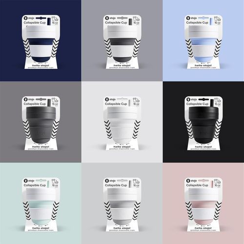 A variety of coffee cups are sitting on top of each other on a table.