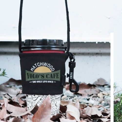 A cup holder that says matchwood yolo 's cafe on it