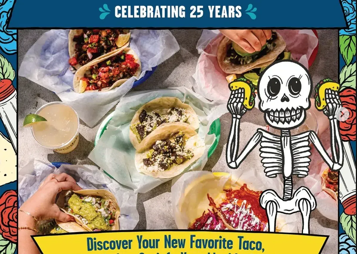 Top-down view of colorful tacos on wrappers with a cartoon skeleton and “Celebrating 25 Years” banner
