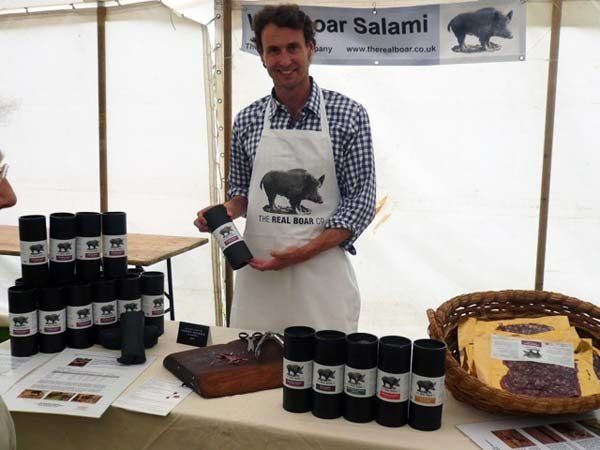 A man wearing an apron with a picture of a boar on it