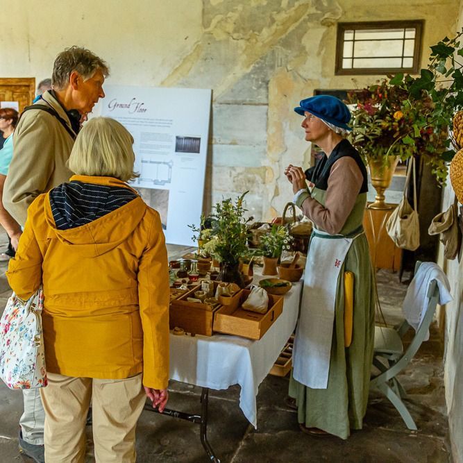 A group of people standing around a table with flowers on it