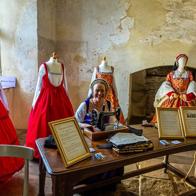 A woman sitting at a table with a sewing machine