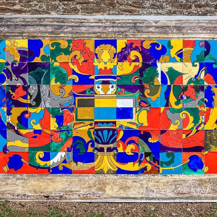 A colorful painting of a coat of arms frieze