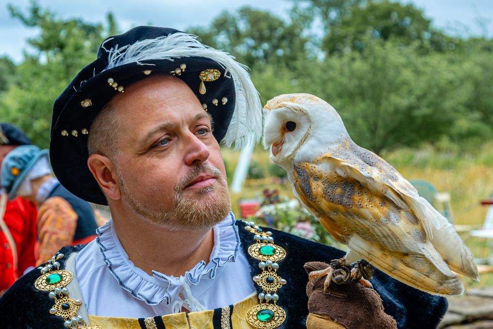 Henry holding an owl on his hand.