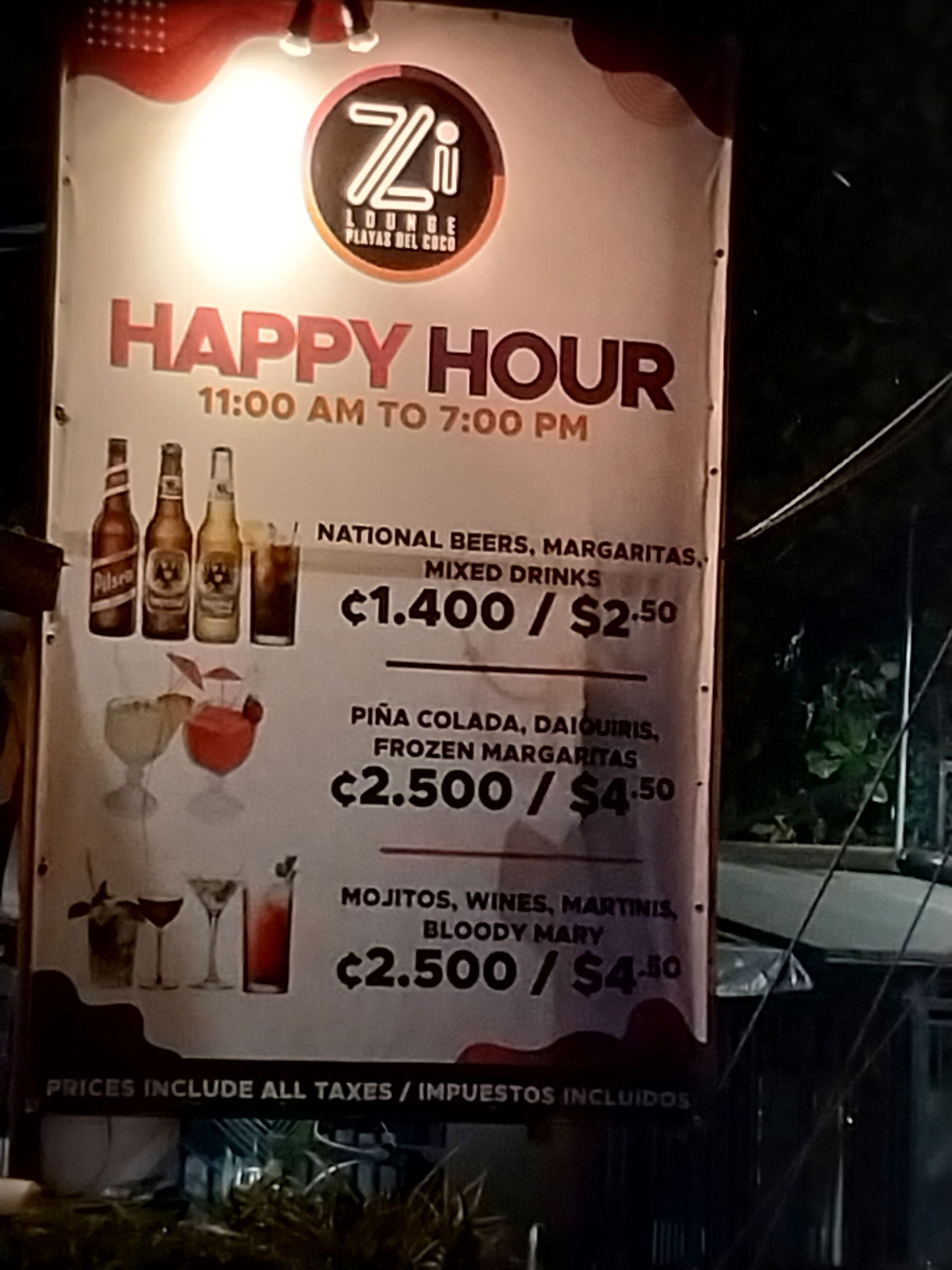 Sign for Happy Hour at Zi Lounge, offering drink specials from 11 am to 7 pm. Price in Colones and dollars.
