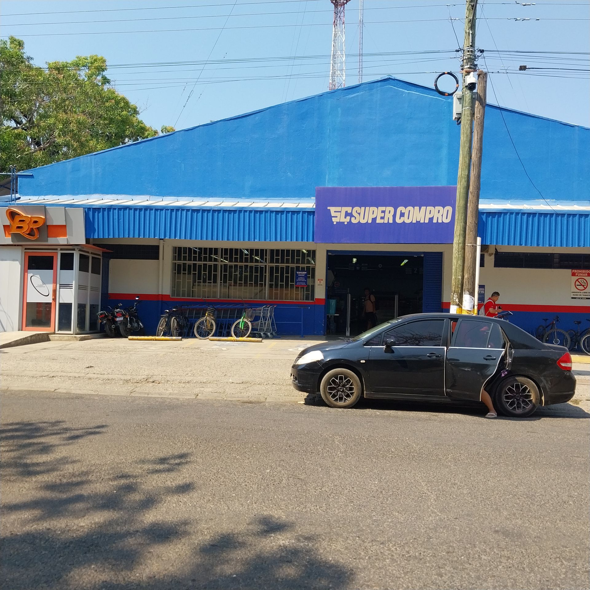 Exterior of a blue-roofed supermarket, 