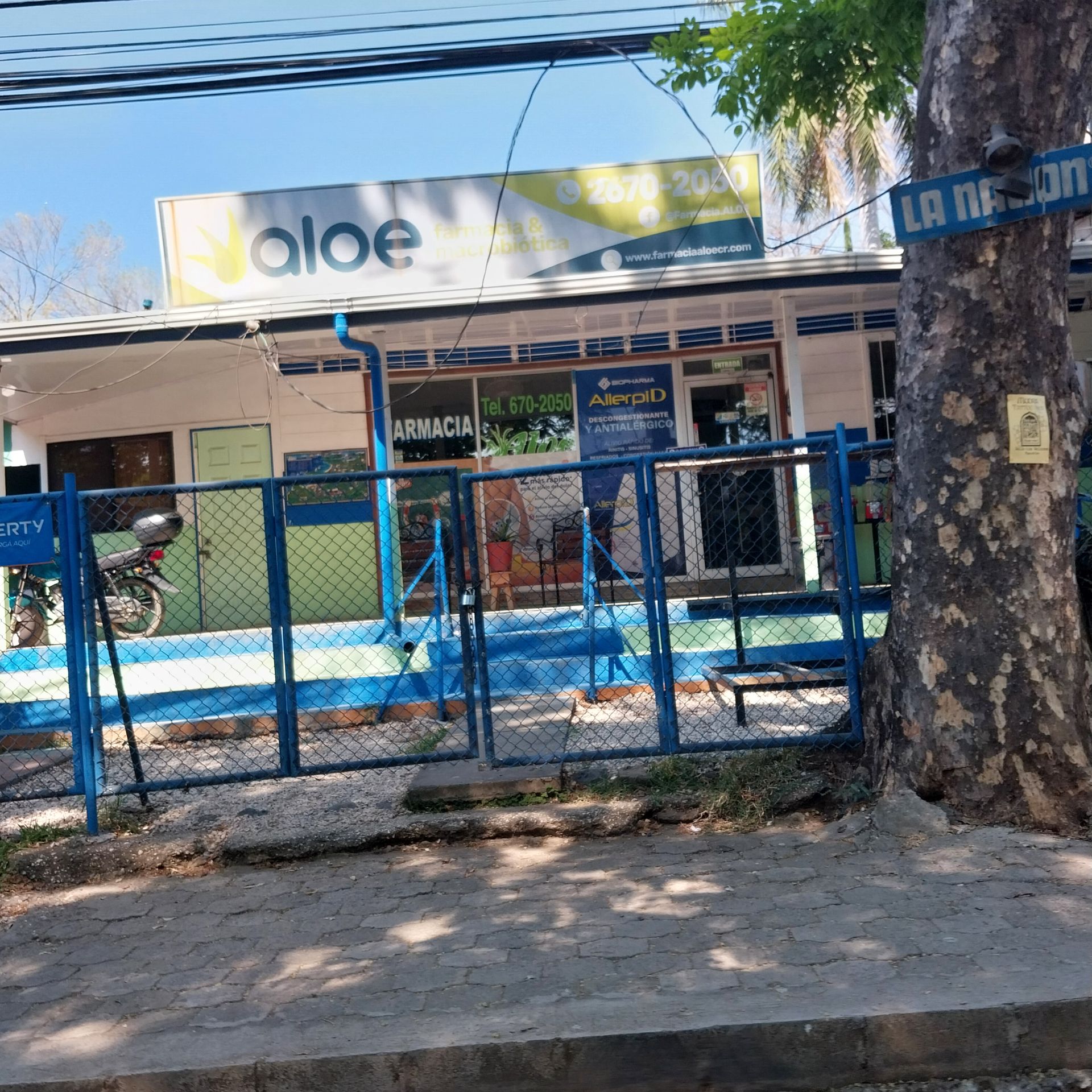 Pharmacy storefront with blue accents, sign that reads 