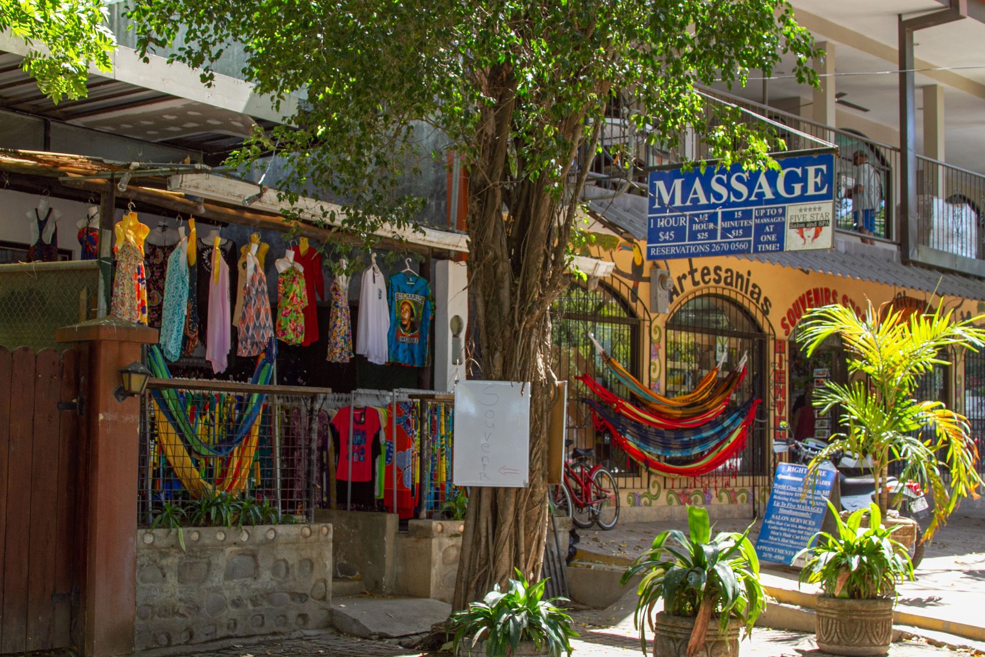 Shops with colorful clothing, hammocks, and a
