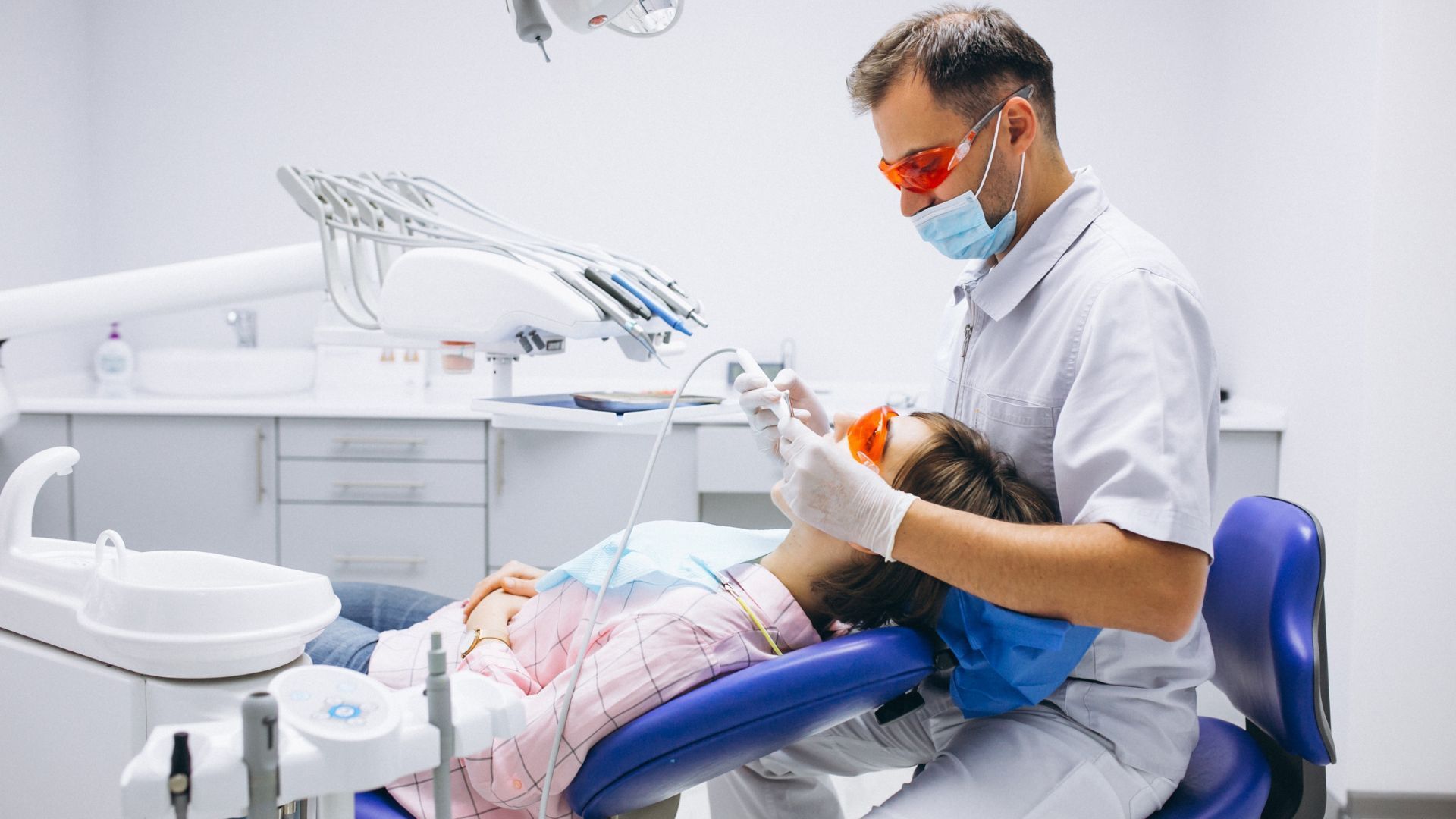 Dental implant illustration: a crown being placed on an abutment attached to the implant within the jawbone.