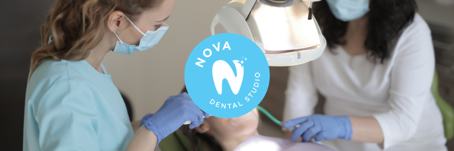 A dentist is examining a woman 's teeth in a nova dental studio.