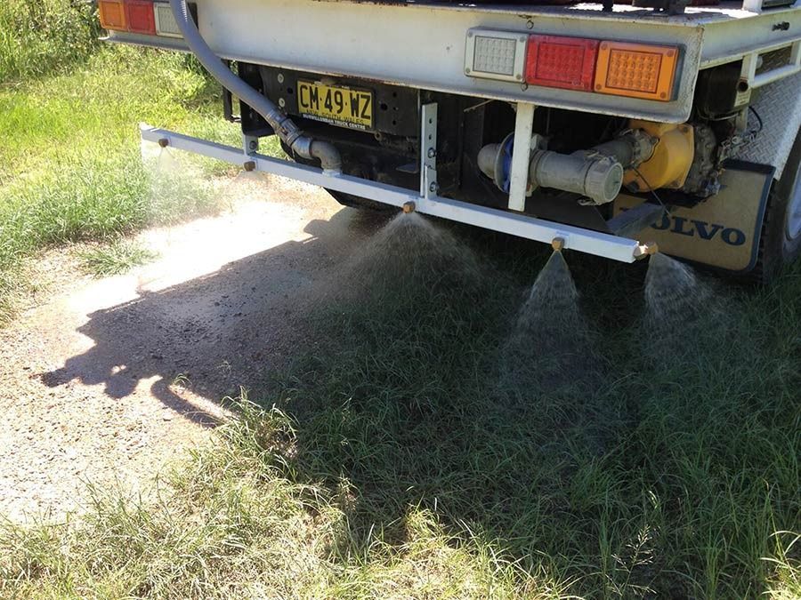 A Volvo Truck Is Spraying Water On A Dirt Road โ Glass~a~Water In Eungella, NSW