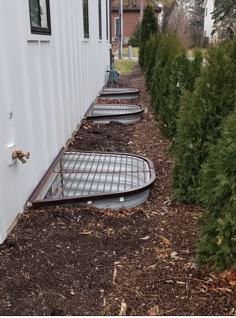 A house with a drain on the side of it