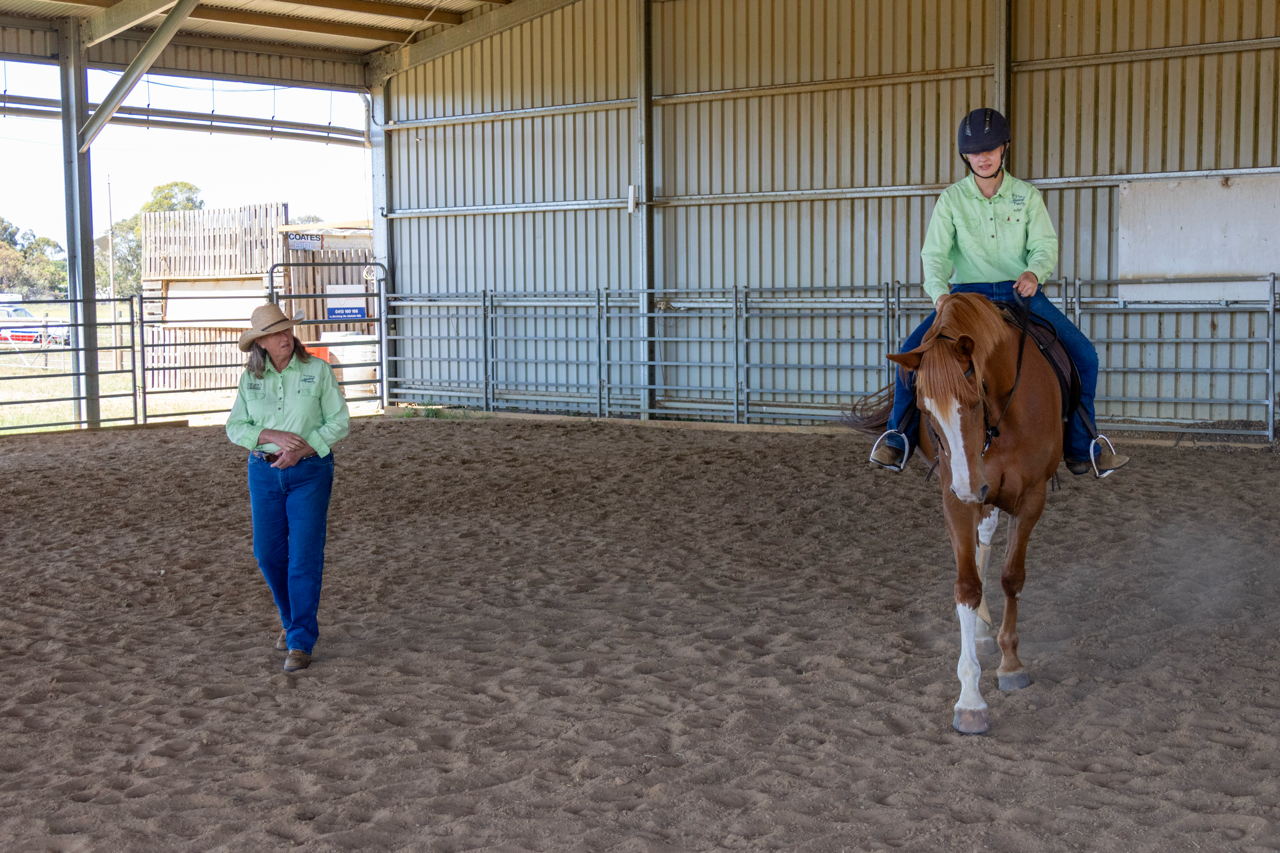 student having a riding lesson in the covered arena