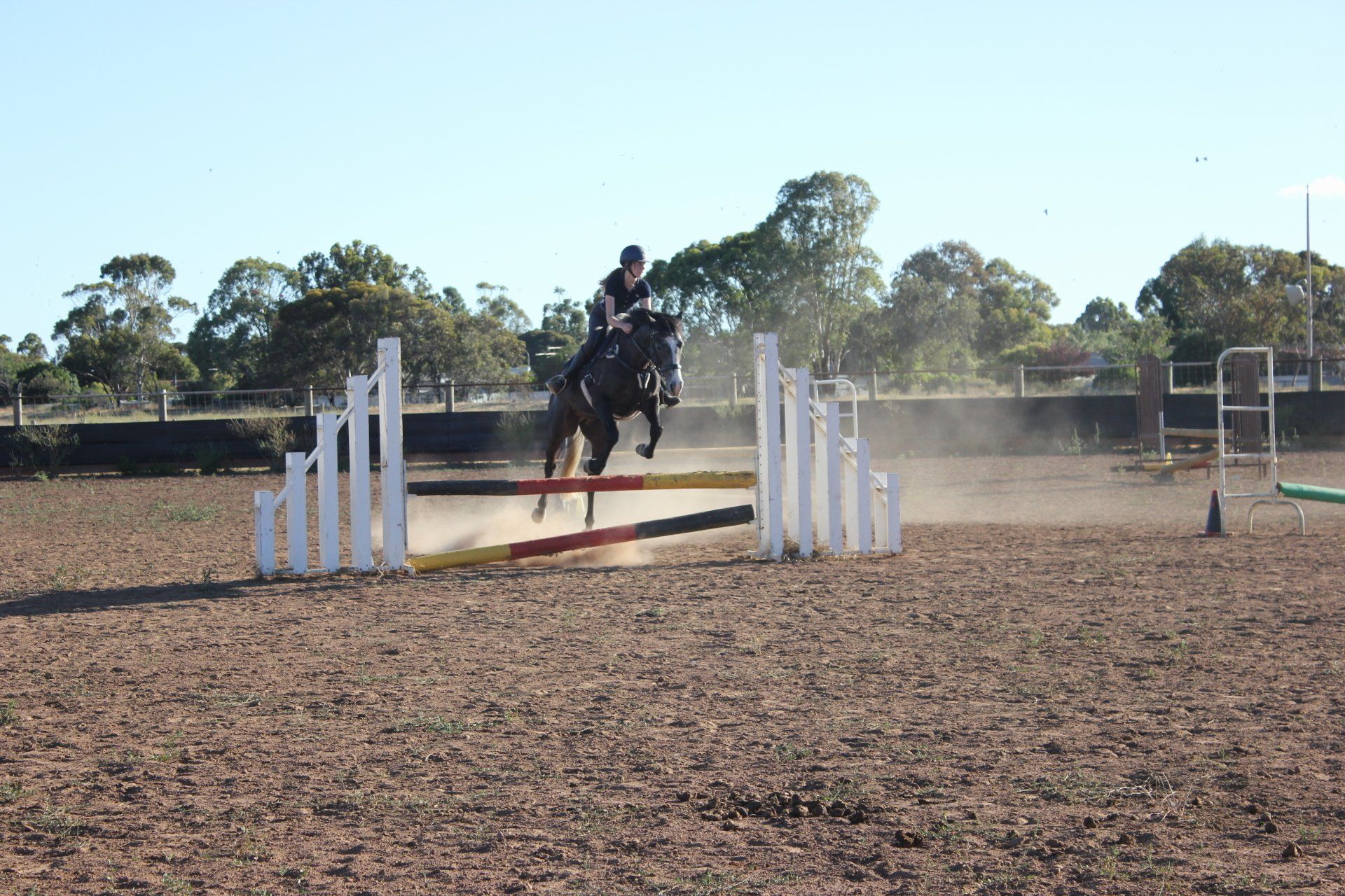 rider and horse  jumping jumps in the outdoor arena