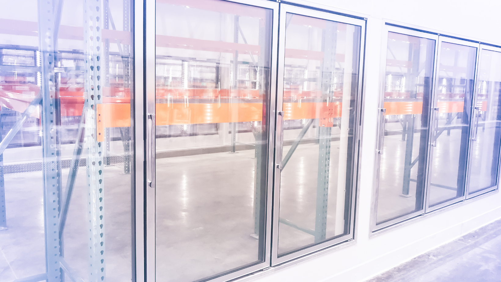Glass warehouse doors with orange shelving visible inside the storage area