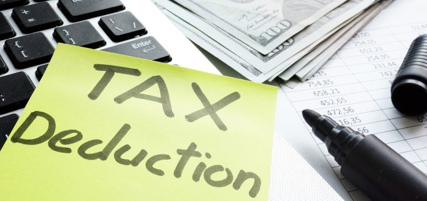 The word Tax Deduction is written on a sticky note.