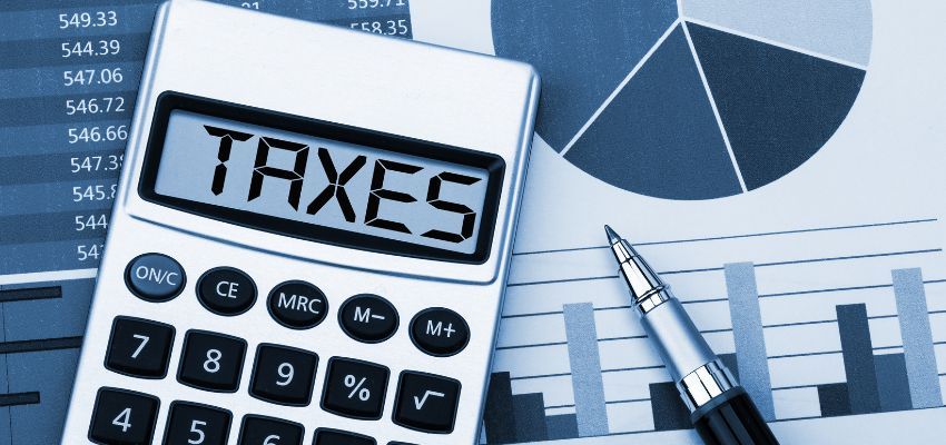 A form for small business tax filing and a calculator with the word TAXES.