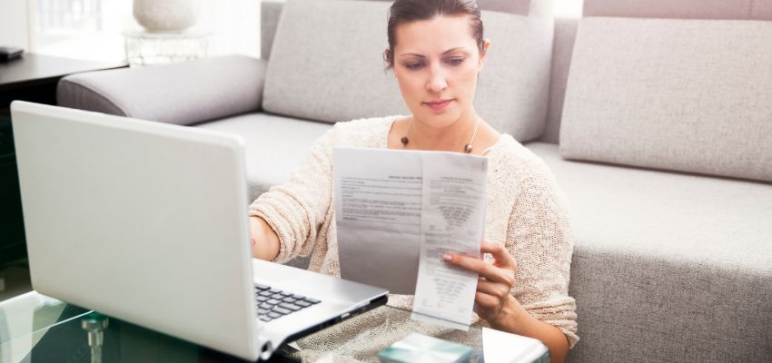 The woman is reading a document about Canadian taxes.