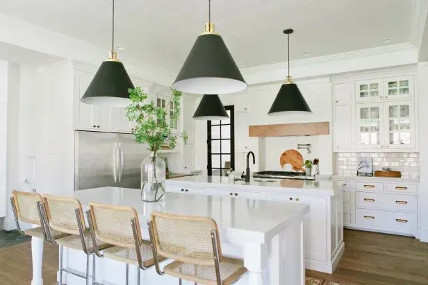 A kitchen with white cabinets and black pendant lights A kitchen with white cabinets and black pendant lights