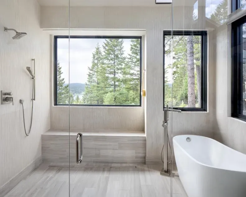 A bathroom with a tub , shower and window A bathroom with a tub , shower and window
