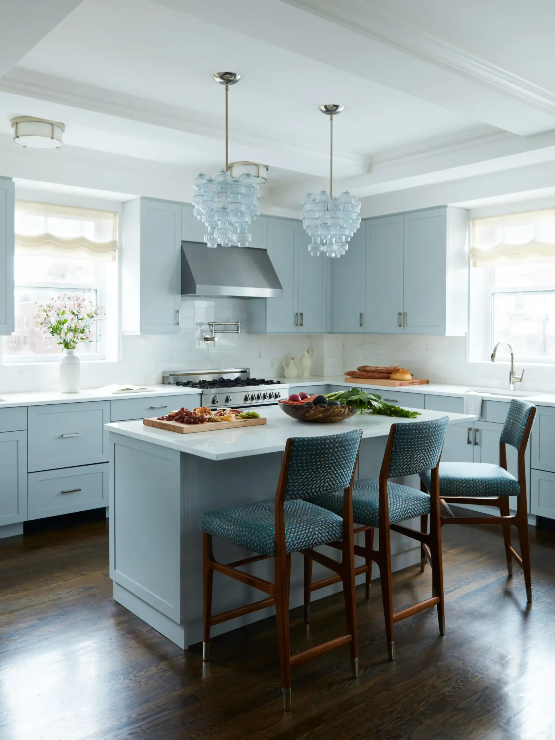 A kitchen with blue cabinets and a large island in the middle