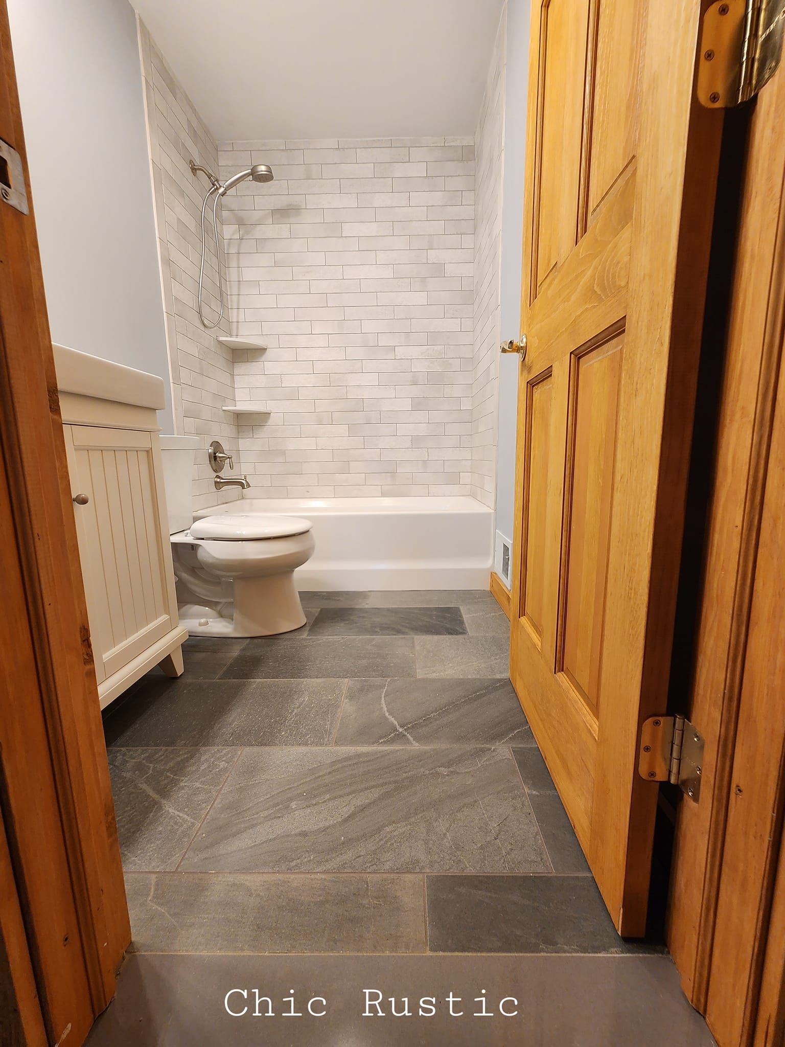 A bathroom with a toilet , bathtub and shower.