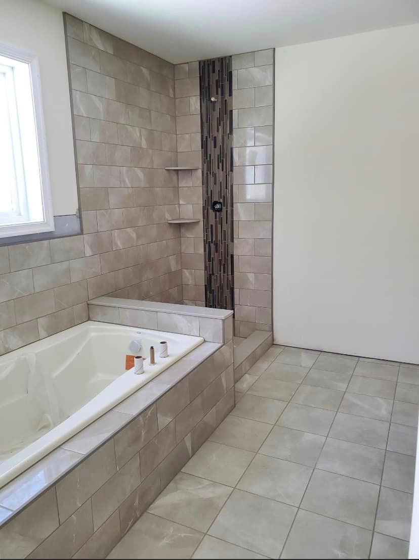 A bathroom with a bathtub and a shower.