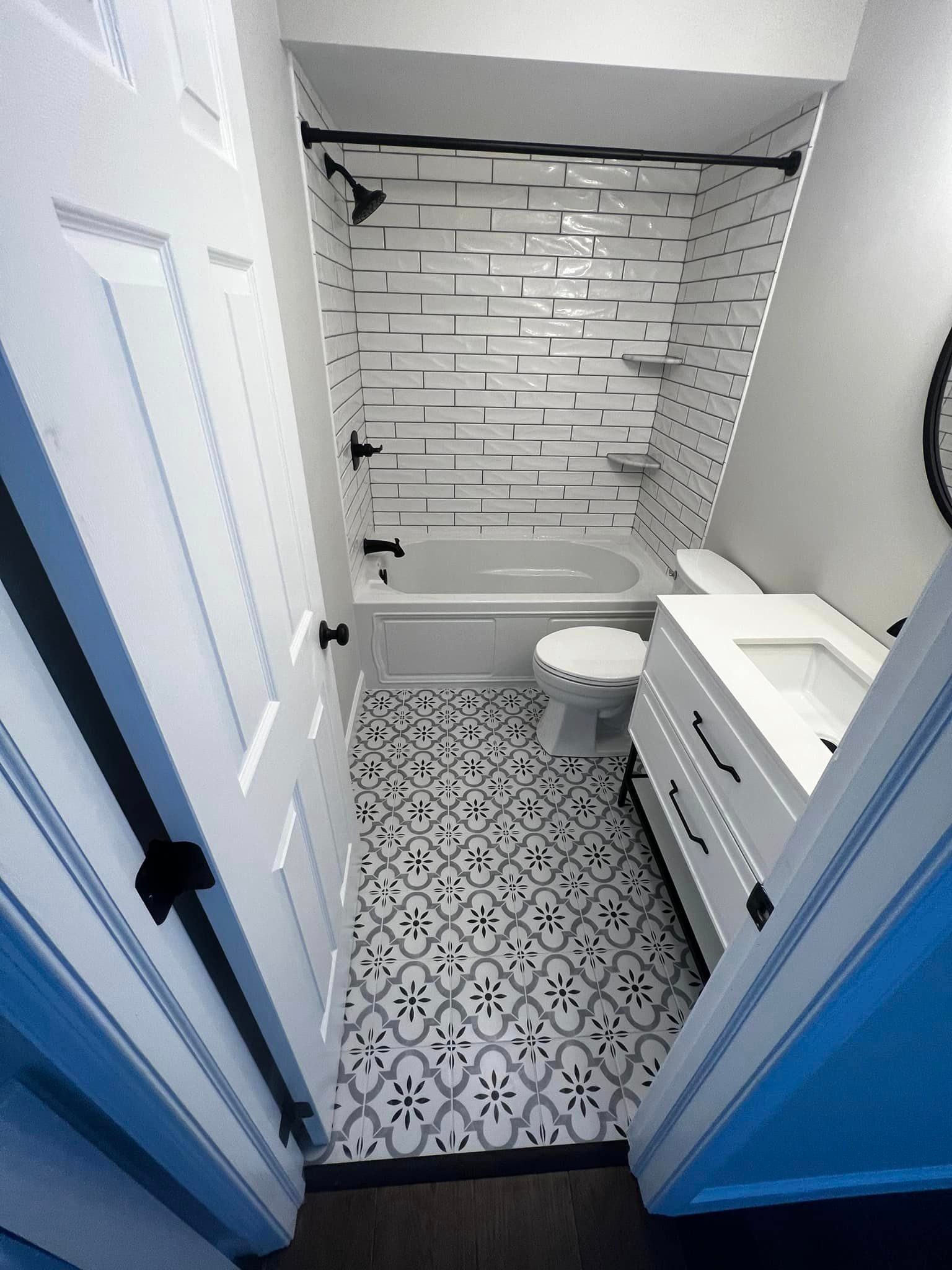 A bathroom with a bathtub , toilet , sink and mirror.