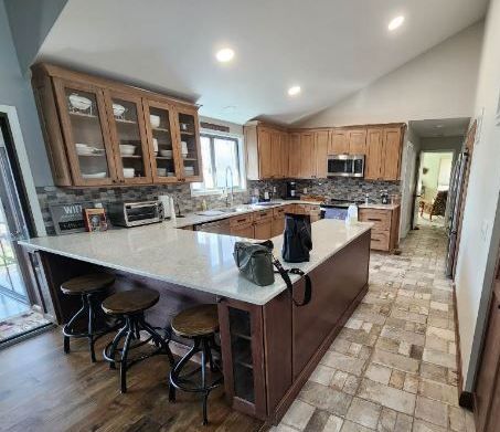 Glass-front uppers, a long counter and room for three stools.