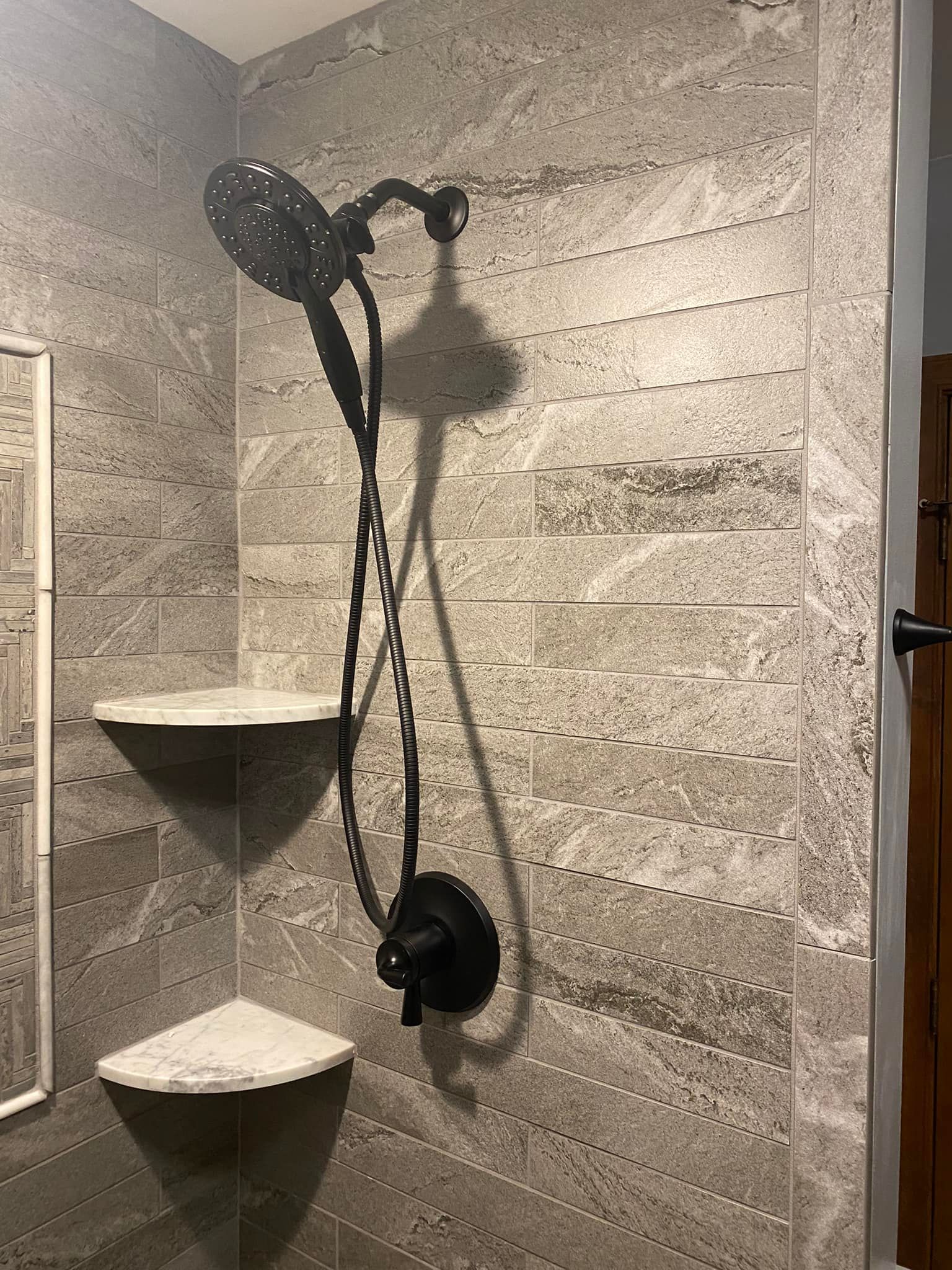 A shower head is hanging from the wall in a bathroom.
