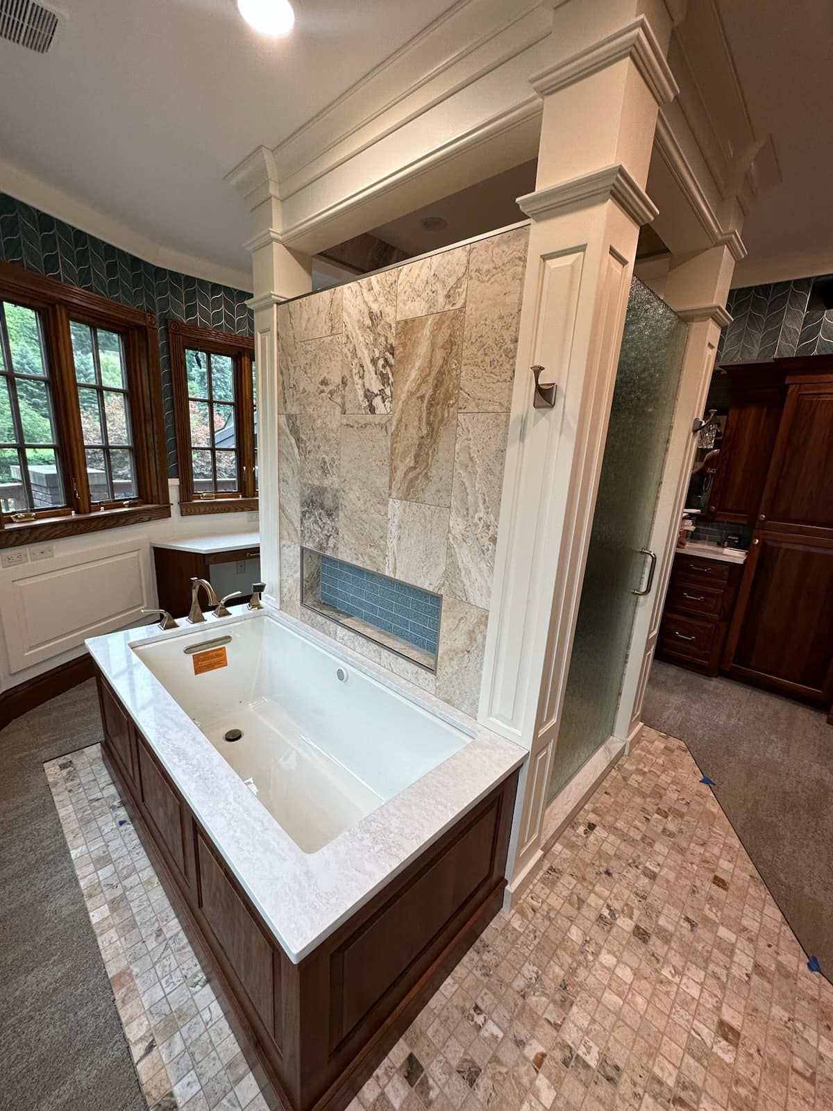 There is a large bathtub in the middle of the bathroom.